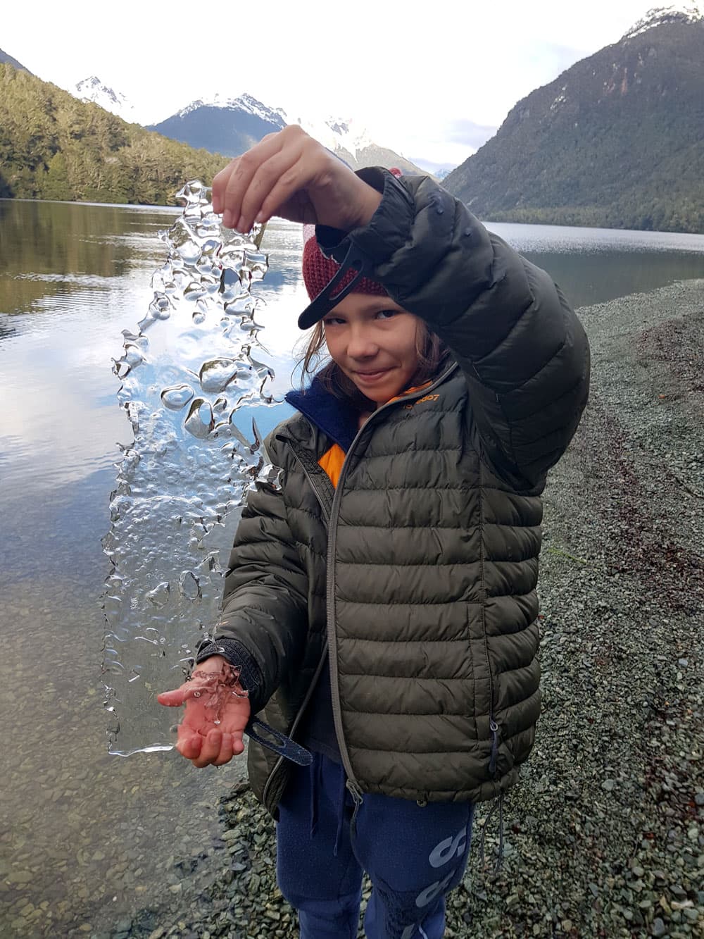 Fiordland Tours guests playing with ice from the lake