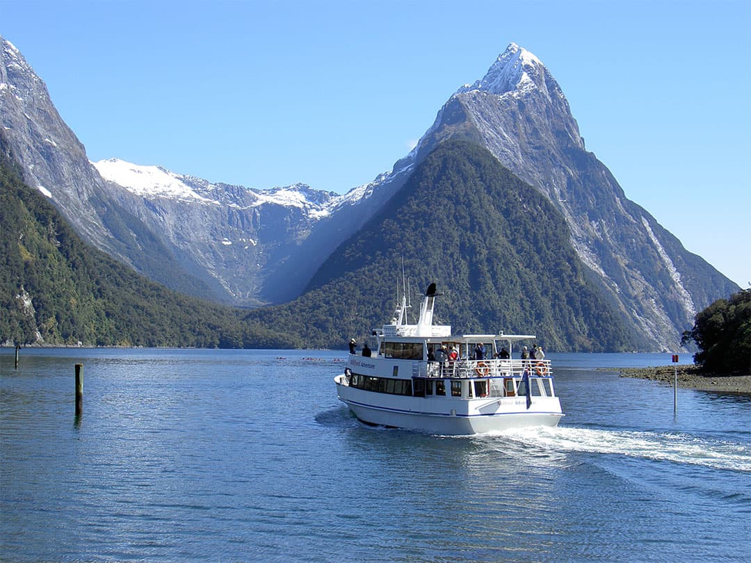 Small nature cruise boating heading out to Milford Sound on the Fiordland Extraordinaire Tour