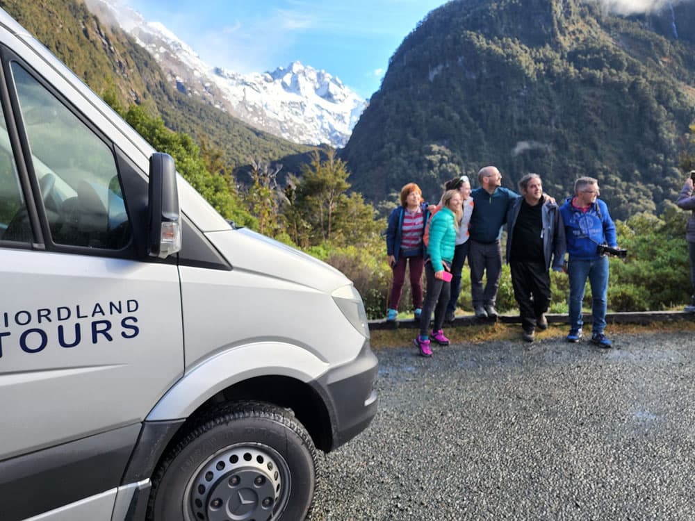 A group of people getting their photo taken by Fiordland Tours near Milford Sound